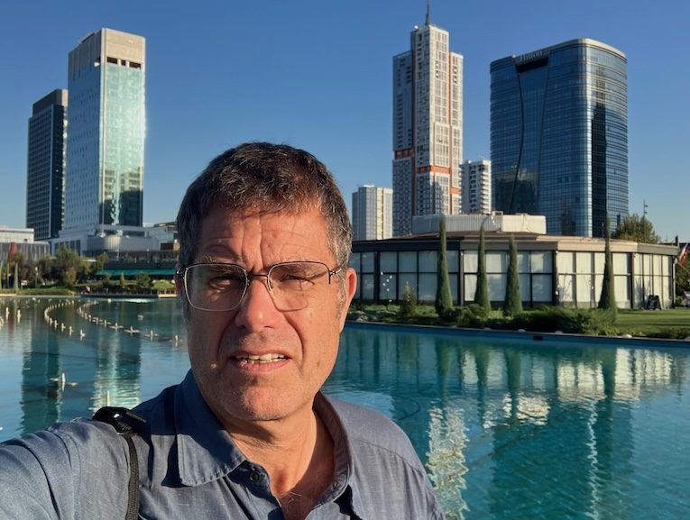 Tashkent travel: Man with city skyline, water feature. Uzbekistan tourism, modern architecture and urban landscape.